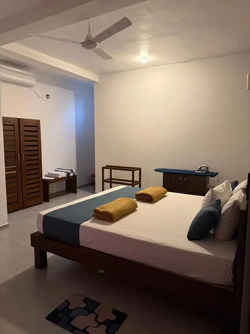 Double bedroom with ceiling fan and fresh towels on the bed