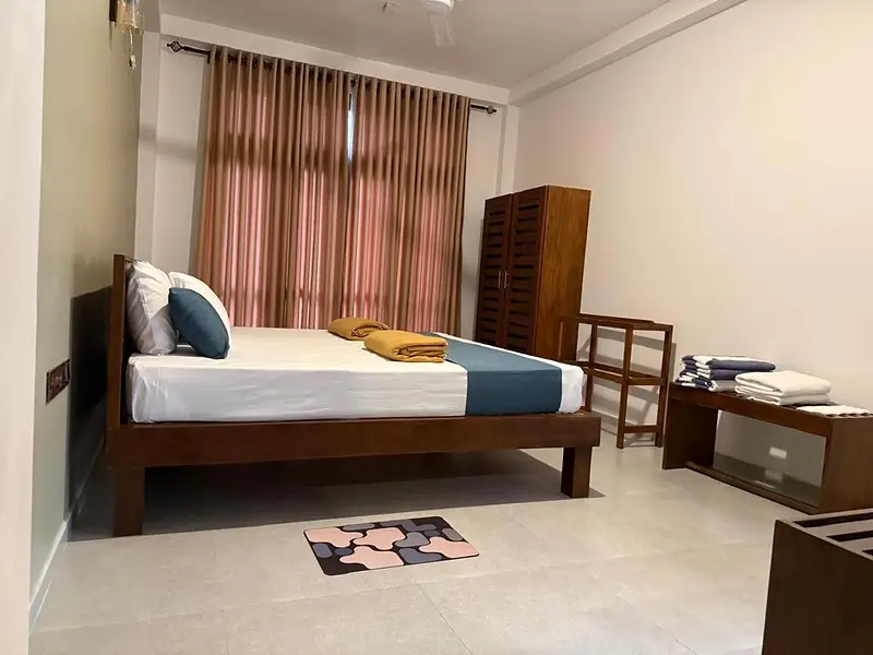 Bedroom with a timber double bed, wardrobe and bedside table