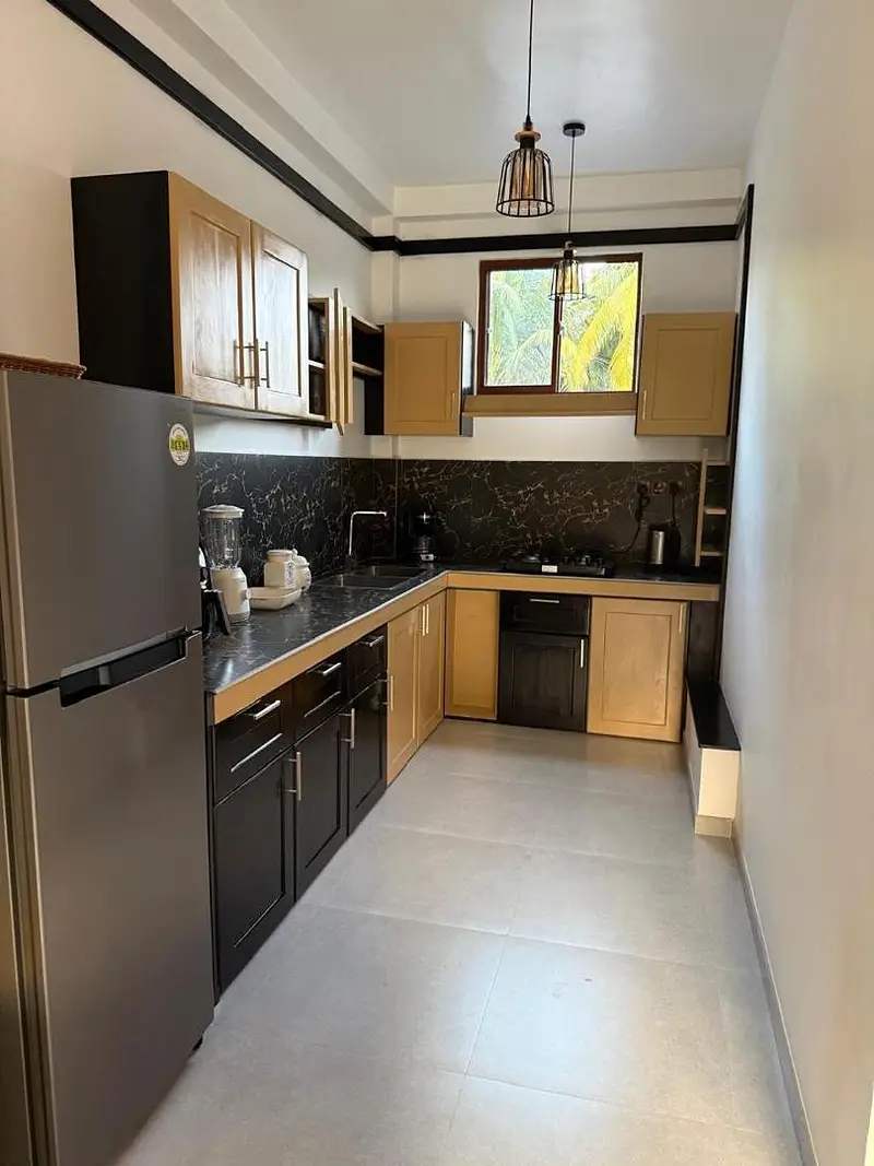 Fitted kitchen with fridge-freezer, oven, hob and plenty of worktop